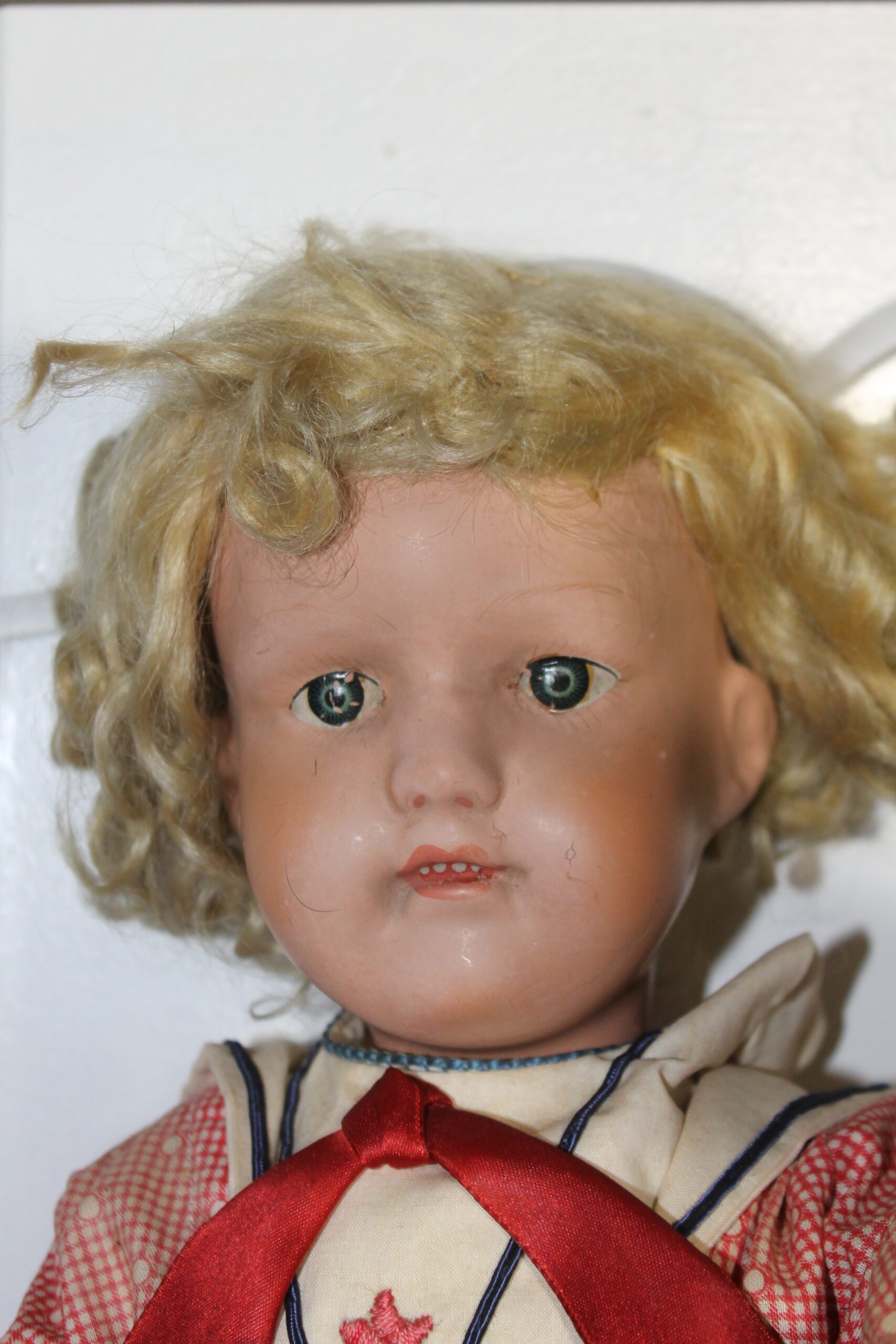 This doll's chipped eyes either speak of all the fun it once had or the neglect it suffered — and they bring its financial value down quite a bit.